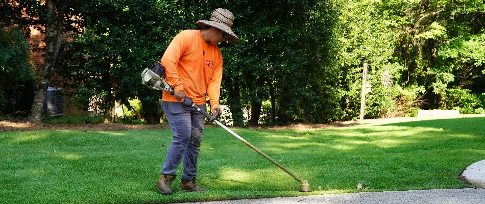Crew edging a lawn in Mountain Brook, AL, after mowing.