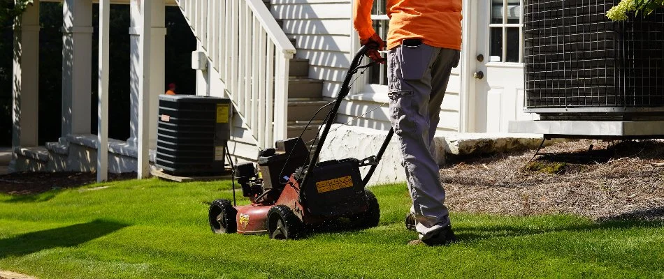 Crew mowing grass near a house in Mountain Brook, AL.