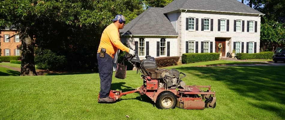 Man on a mower cutting grass in Mountain Brook, AL.