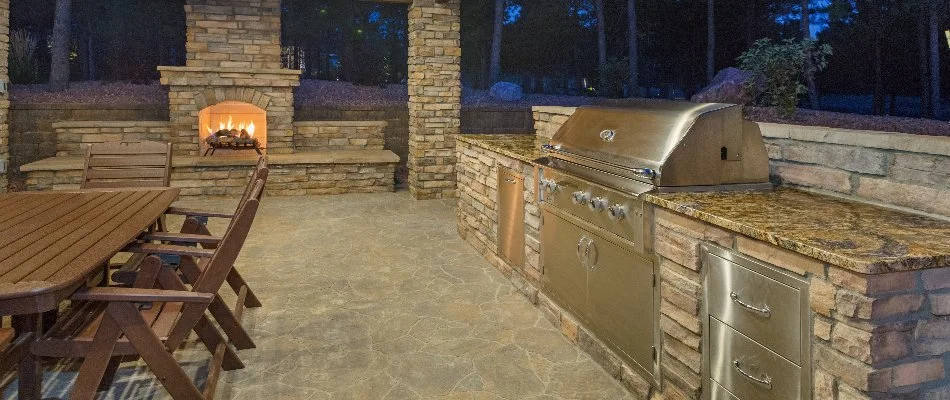 Pavilion area in Mountain Brook, AL, with an outdoor kitchen and fireplace.