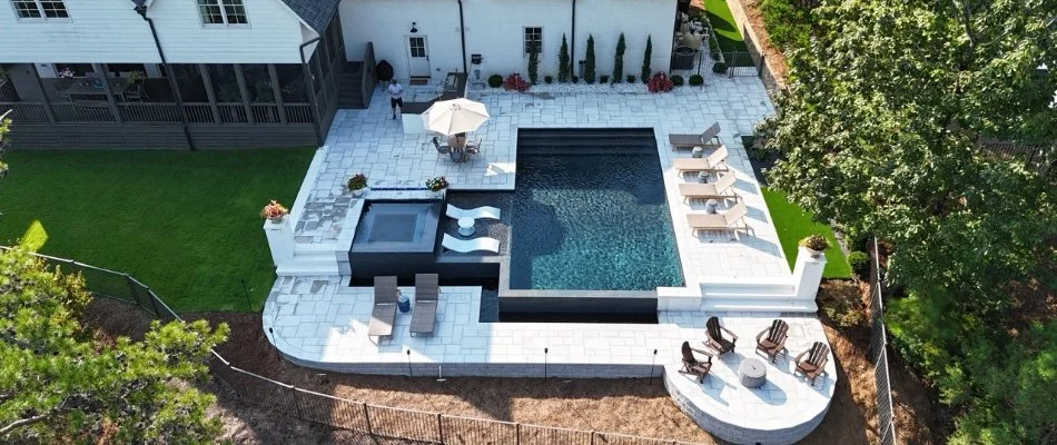 Aerial view of a pool area in Madison, AL, with a patio and seating.