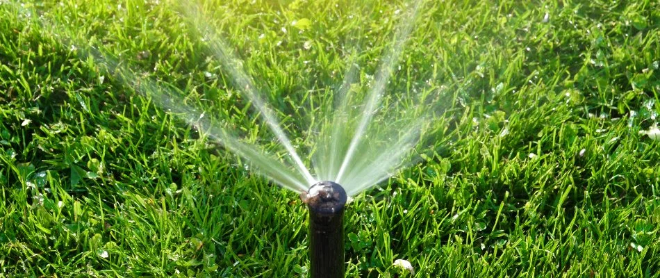 Sprinkler system running on a green lawn in Mountain Brook, AL.