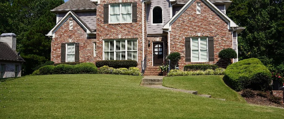 Manicured lawn and landscape on residential property in Mountain Brook, AL.