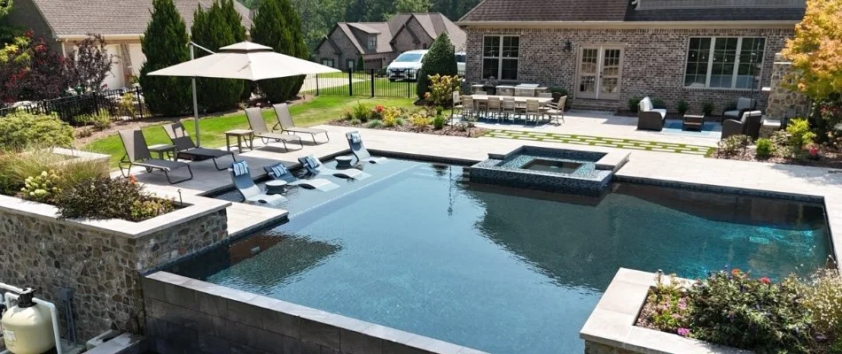 Outdoor living space in Liberty Park, AL, with a pool and lounge chairs.