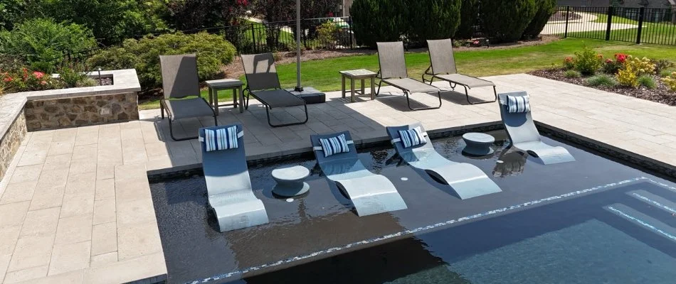 Pool and deck in New Market, AL, with chairs.