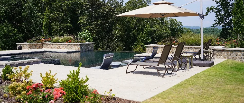 Pool patio area with chairs and landscaping in Mountain Brook, AL.
