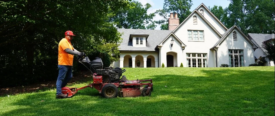 Professional mowing grass in front of a house in Mountain Brook, AL.