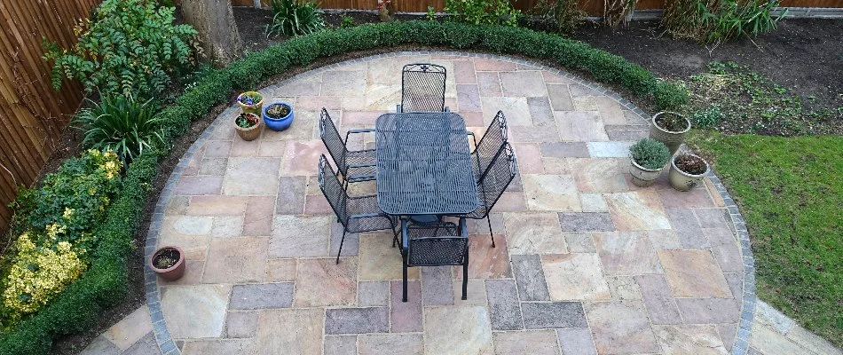 Patio in Mountain Brook, AL, made from natural stone with landscaping.