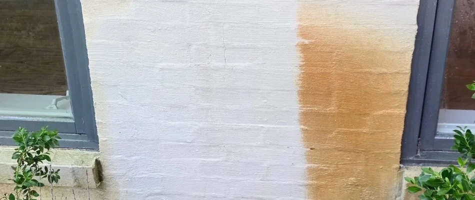 White wall of a building in Mountain Brook, AL, partially cleaned.